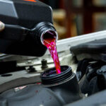 The pink radiator water is filling in the radiator